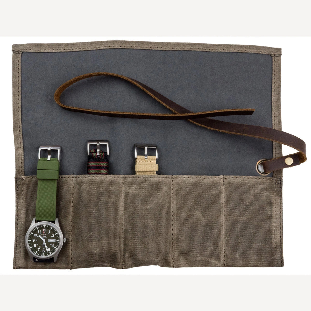 Olive waxed canvas watch roll laid open with 4 pockets, a watch and spare straps