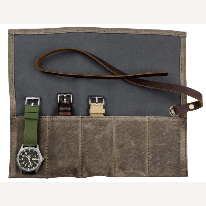 Olive waxed canvas watch roll laid open with 4 pockets, a watch and spare straps